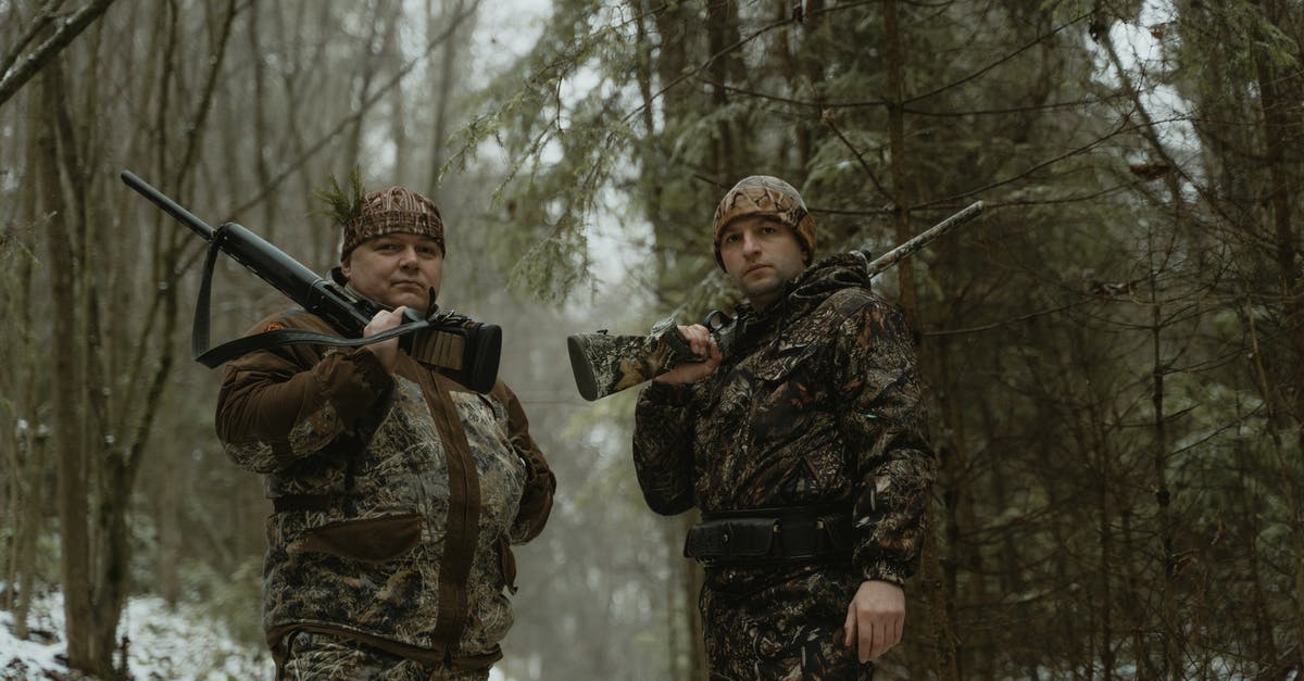 How quickly do the hunters respawn? - Two Men Standing on Forest Holding Rifles