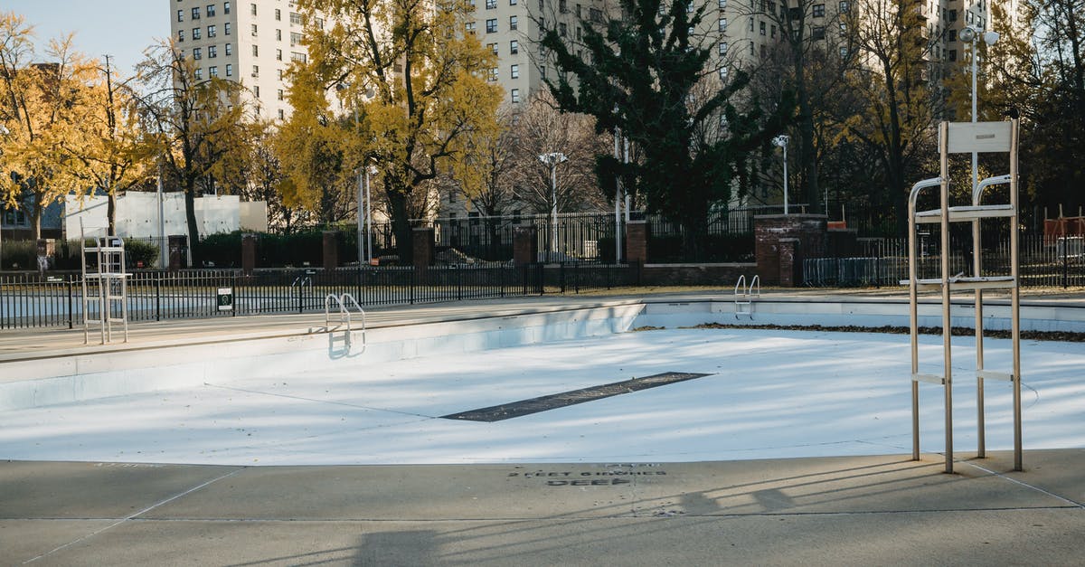 How tall is the ladder? - Empty pool in park in fall near fence in city