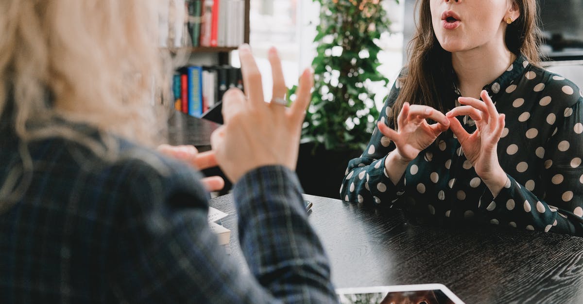 How to a show message only once? - Young female friends communicating using sign language in library