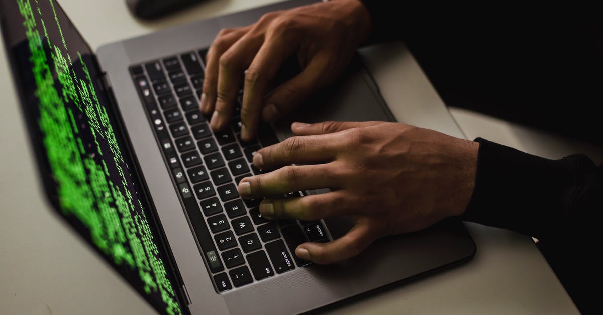 How to cancel attack command? - From above of crop anonymous male hacker typing on netbook with data on screen while sitting at desk