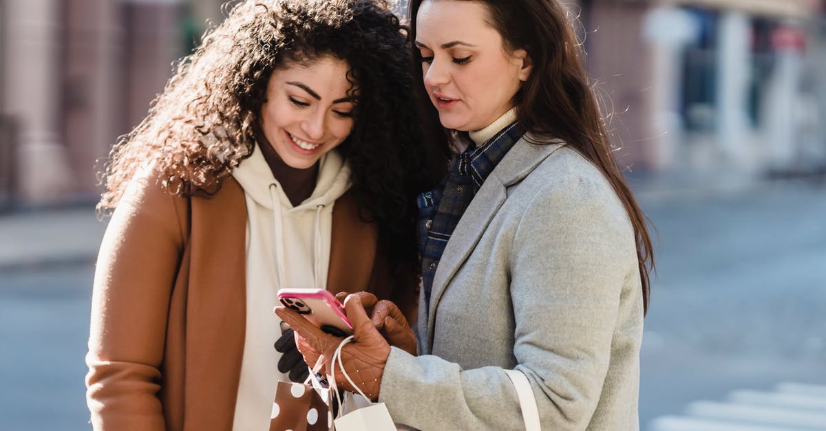 How to check Friendship in Pokemon Legends: Arceus? - Girlfriends in city street checking information on smartphone