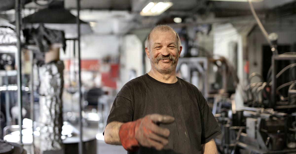 How to create a HUD toggle bind in Source engine games? - Cheerful senior white hair craftsman in heavy duty gloves laughing in workshop while looking at camera