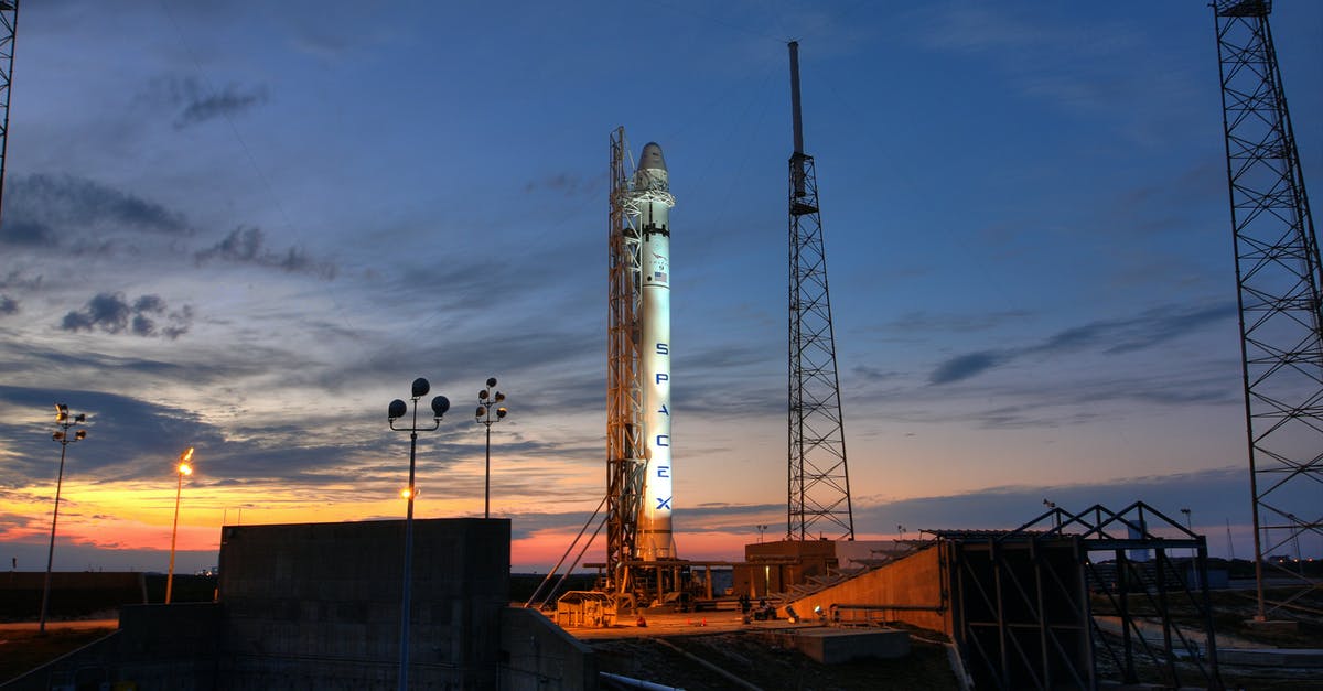 How to design heavy lifter rocket - Solid rocket installed on metal launch construction in spaceport and ready for taking off against colorful sunset sky