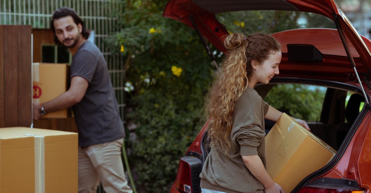 How to get a Red Boundary - Couple getting carton boxes out of red car while relocating in new home