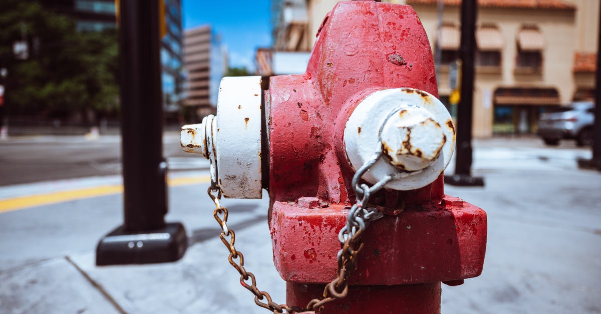 How to get Charmander as your Pokémon in Red Rescue Team? - Typical red fire hydrant with rusty chain located on roadside in modern city on sunny day