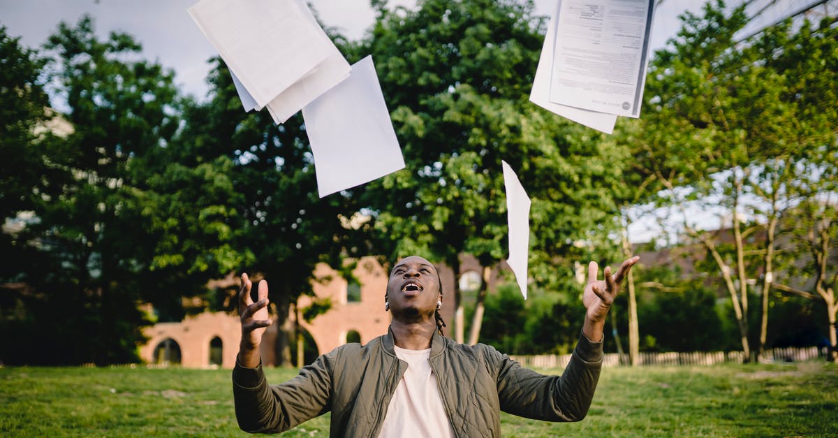 How to get exclusive skins in Smite? - Overjoyed African American graduate tossing copies of resumes in air after learning news about successfully getting job while sitting in green park with laptop