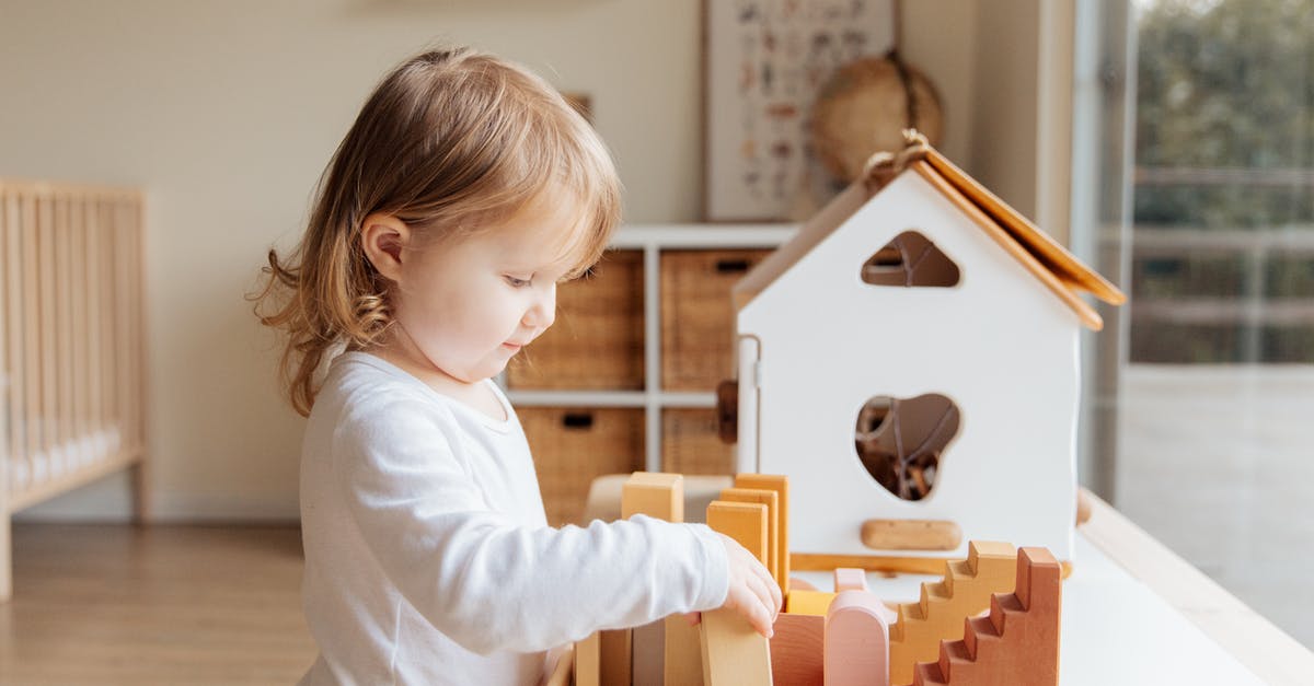 How to get out of command block loop in education edition - Cute little girl playing with wooden blocks at table near window at home