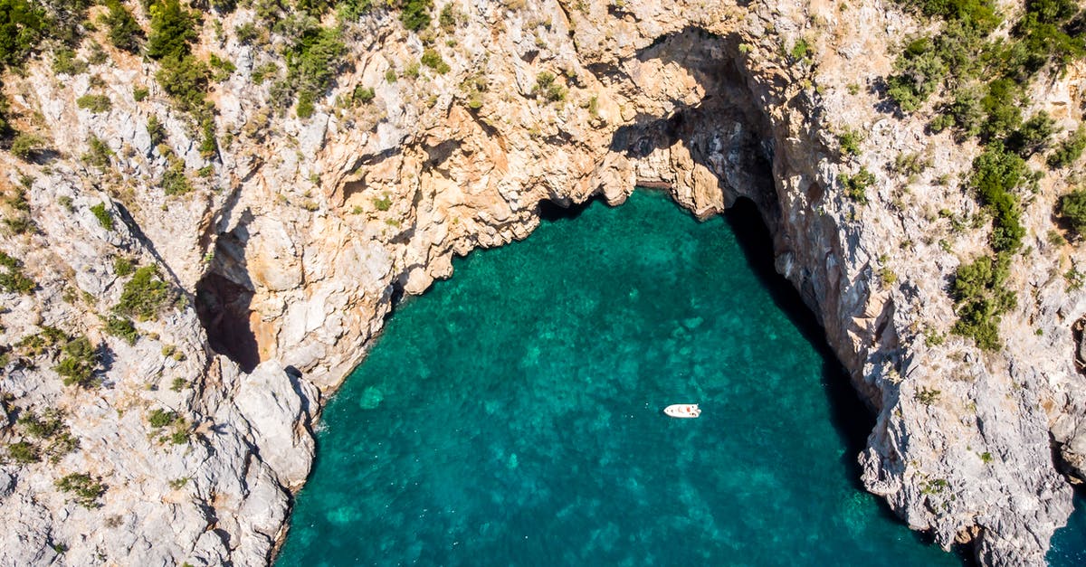 How to get Rock smash in pokemon emerald version - Breathtaking drone view of white yacht sailing on emerald sea surrounded by rough rocky cliff with green trees on top on sunny day