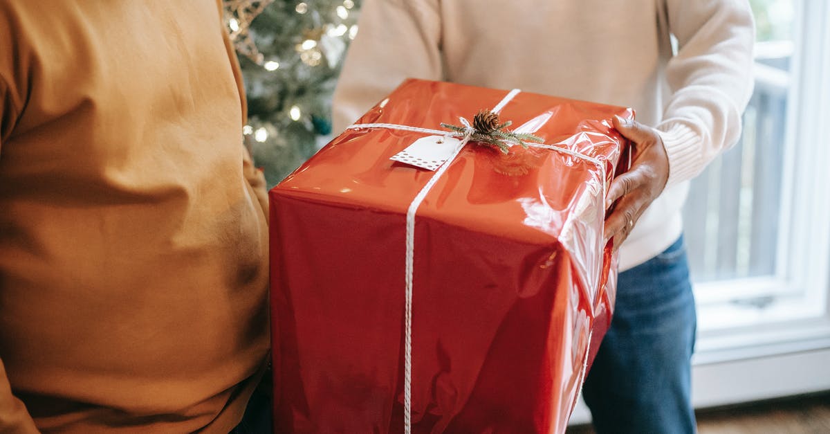 How to give an inverted nbt tag to a mob? - Crop anonymous African American father giving big present box to teen son during festive celebration at home