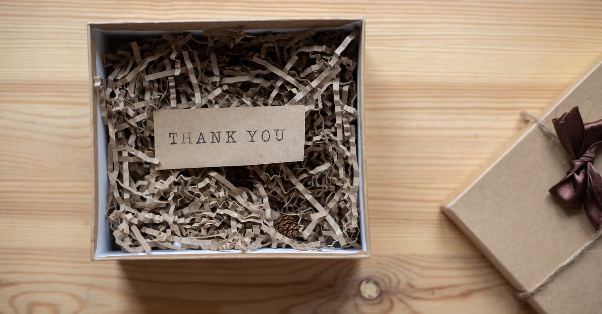 How to give an inverted nbt tag to a mob? - Top view of opened carton present box with small postcard with Thank You inscription and paper stuffing on wooden table