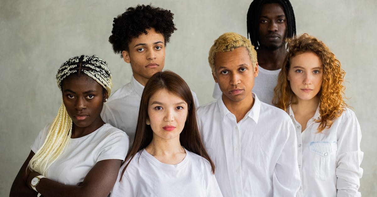 How to join servers? - Serious diverse multiracial people standing close together representing concept of unity  and looking at camera against gray background