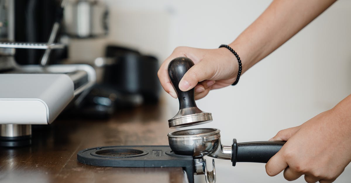 How to pin Steam games to Windows 7 task bar - Crop anonymous barista pressing aromatic coffee beans into filter block by using tamper while standing in light kitchen nearby professional brewing machine