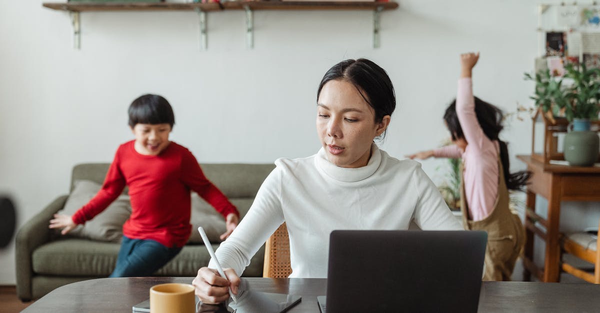 How to play Project M using a backup on USB? - Asian mother working online using laptop and taking notes on tablet with stylus and cheerful children making noise and running behind in living room