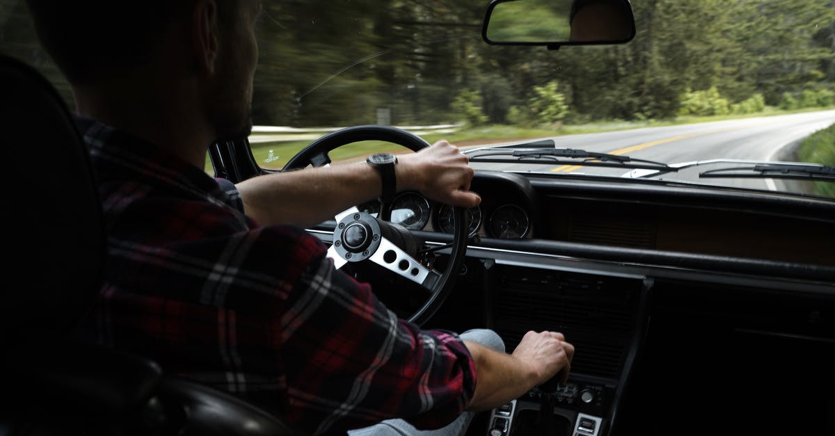 How to predict & control ghost movement in Pac-Man [closed] - Back view of crop anonymous male driver in casual outfit in contemporary car riding along asphalt road through forest in daytime