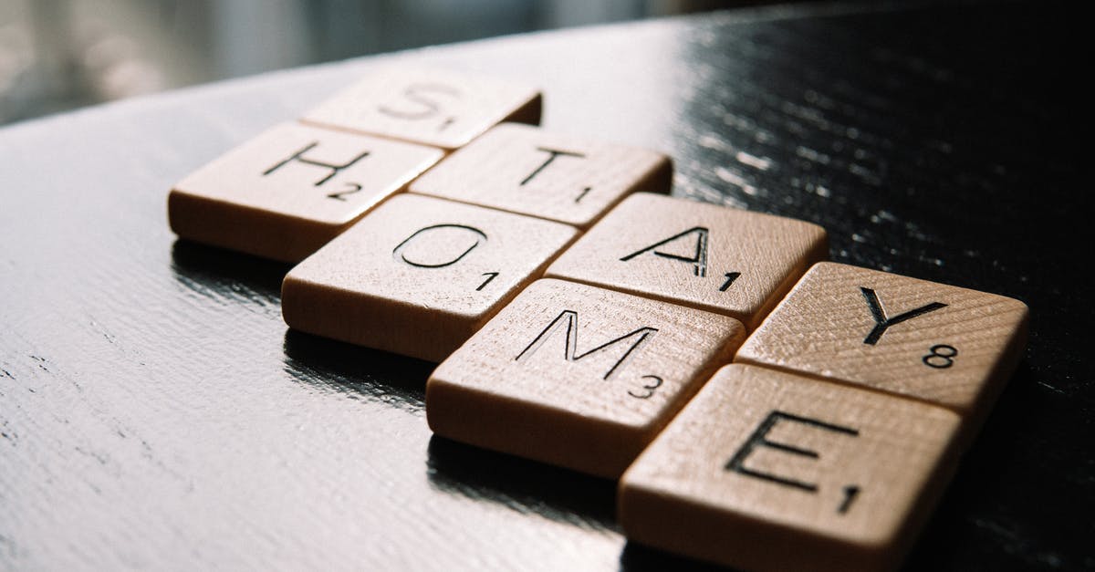 How to save information about selected mods? - High angle of scrabble letter tiles arranged on black wooden table in inscription Stay Home in living room