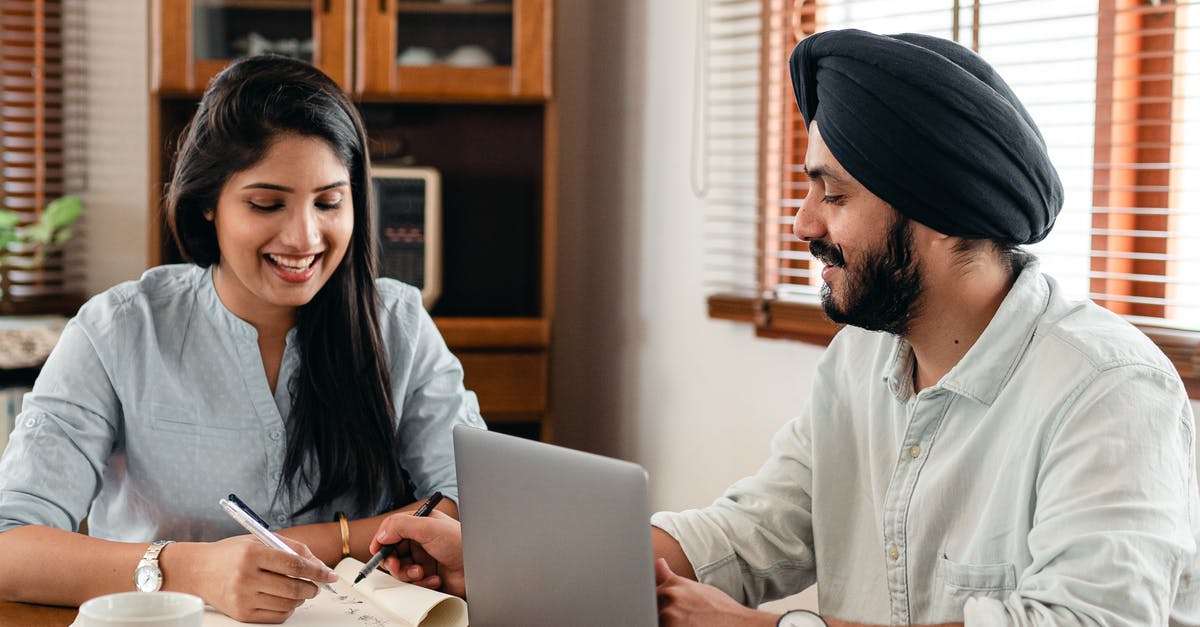 How to solve C&C Zero Hour LAN connection issues? - Happy Indian couple using laptop while doing homework together