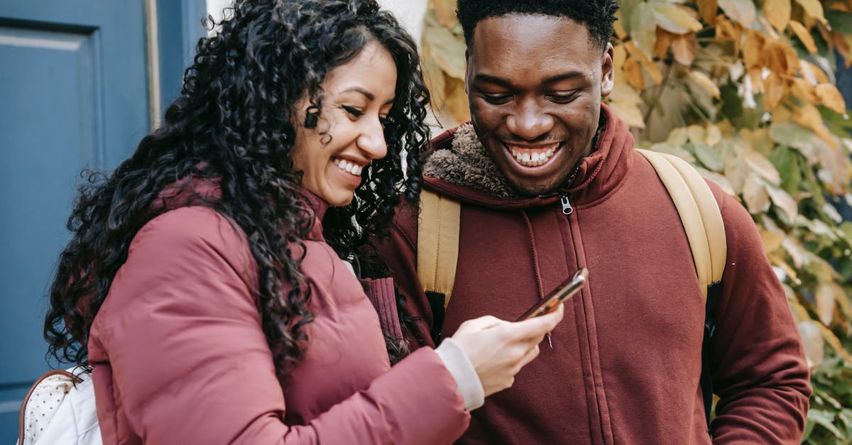 How to split/share teleportation portal scroll in DotA 2? - Cheerful diverse couple smiling and sharing smartphone