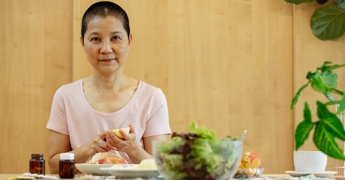 How to treat tiredness? - Sick positive Asian woman having breakfast at table