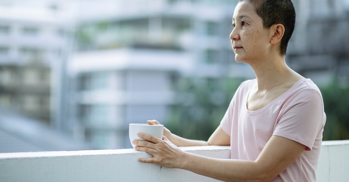 How to treat tiredness? - Sick Asian woman with cup of tea suffering from cancer