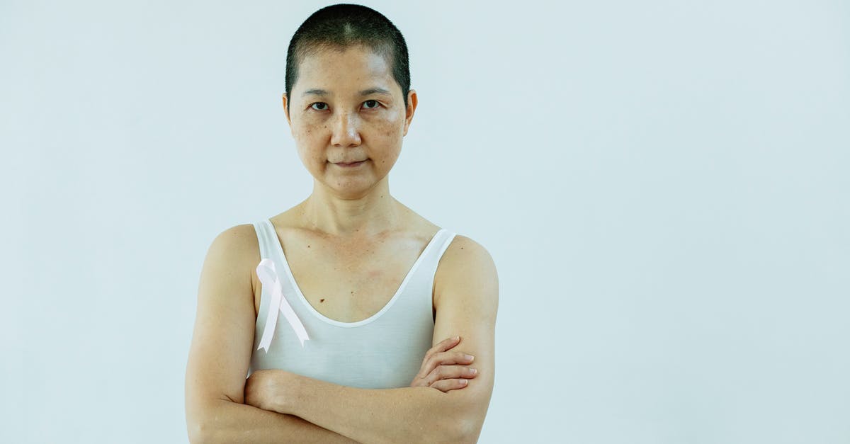 How to treat tiredness? - Asian woman with arms folded and breast cancer