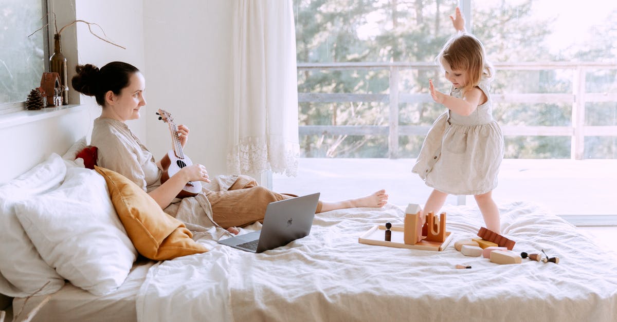 How to unlock the extra content playing by yourself - Happy young woman playing ukulele for daughter at home