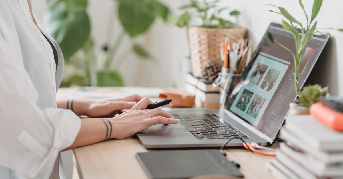 How to use boost when using the keyboard? - Woman working retouching photo on laptop at convenient workplace