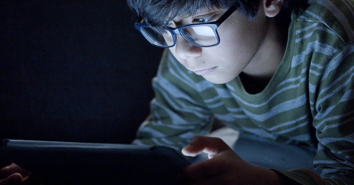 How to use TM Dig in Pokemon Emerald - Boy Wearing Eyeglasses Using a Tablet in the Dark Room