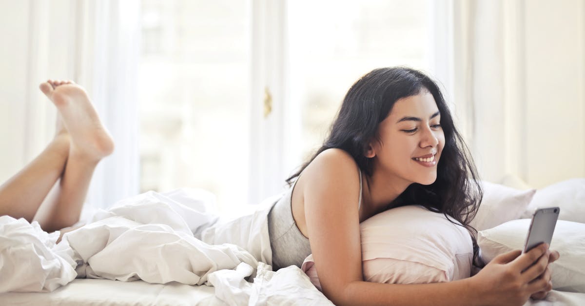 I cannot use Shift+W+1 at the same time - Happy young woman browsing phone on bed