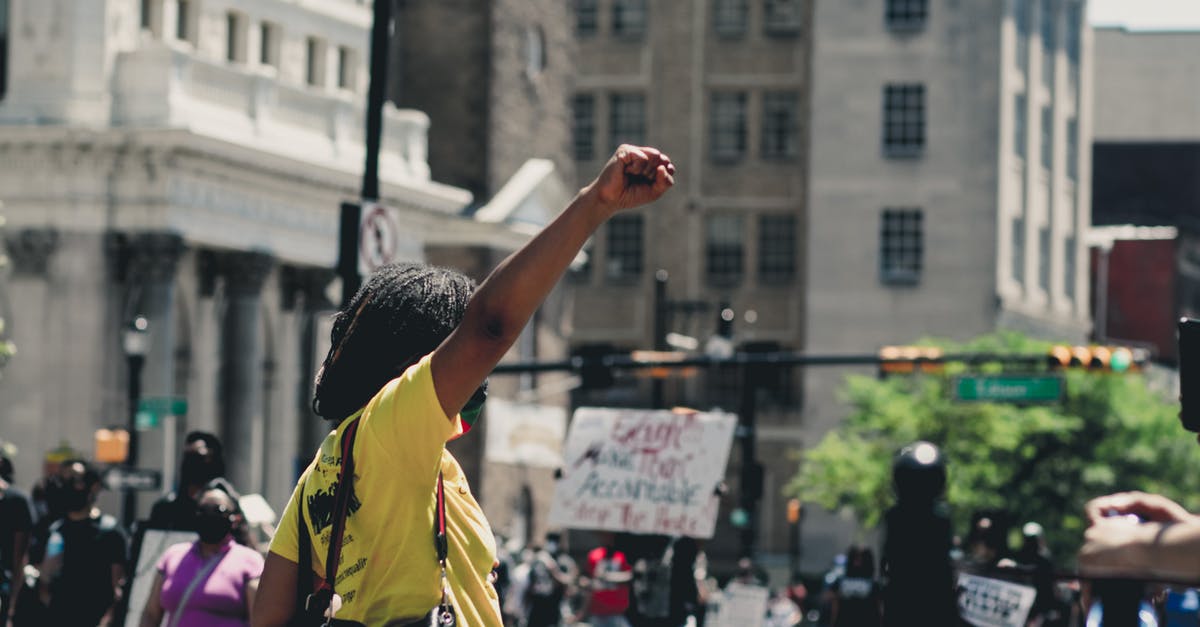 If I change servers on AstroNest will I lose any progress? - African American female raising fist while standing in demonstration against police brutality in daylight