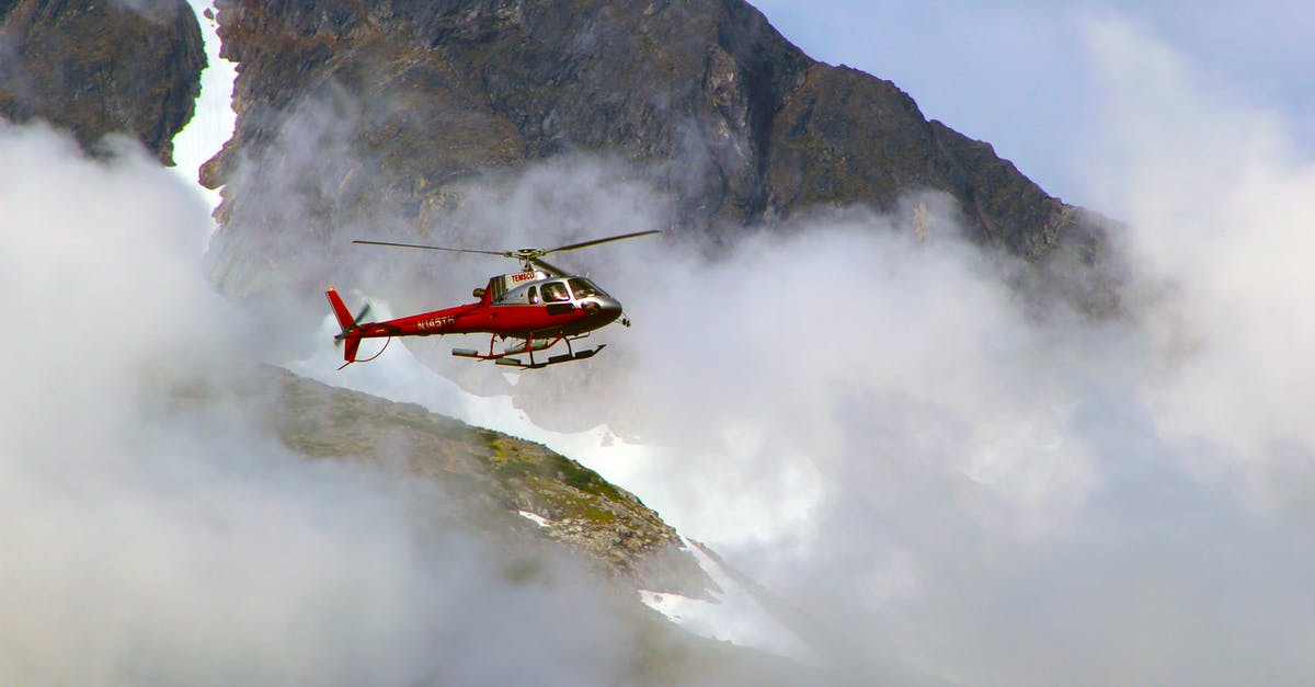 If I fly around mountains, can AA still damage my planes? - Red Helicopter on Top of Foggy Mountain