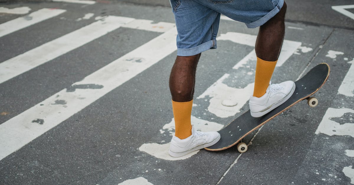 If I respec skills with a skill at level 4 ready to be morphed will I keep my progress? - Crop unrecognizable African American male skater in denim shorts and t shirt standing on skateboard on asphalt road ready to ride