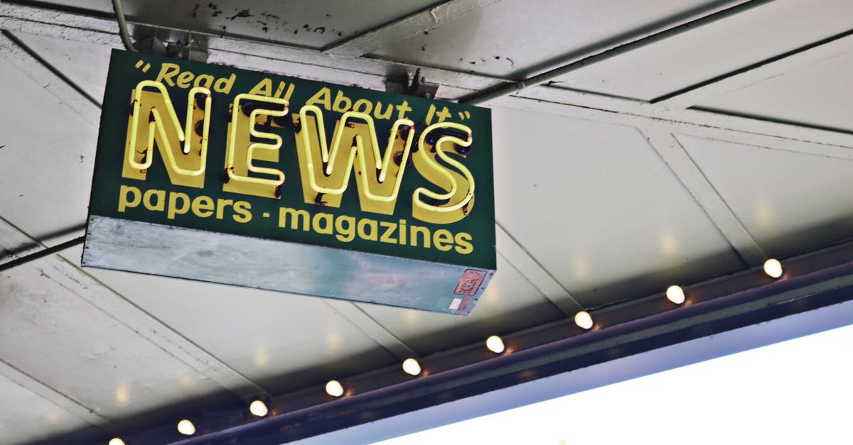 In Bidiots, what do the texts from the art buyers mean? - From below of illuminated signboard with news papers magazines inscriptions hanging on metal ceiling on street