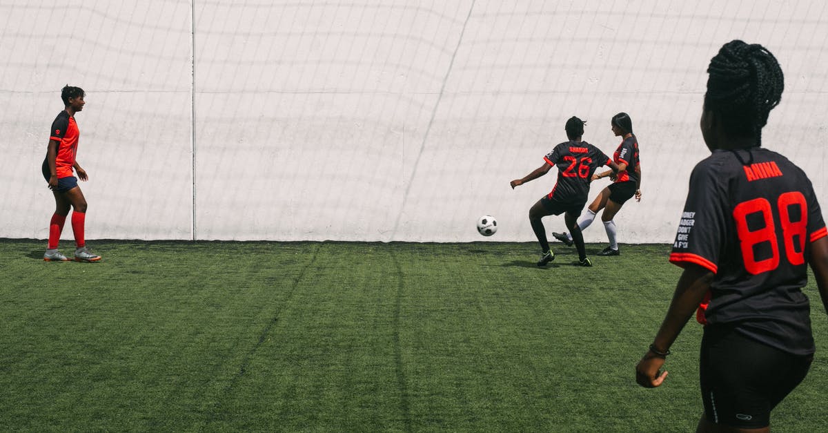 In what levels is the Green Demon Challenge possible? - African American females actively playing in football on grass field of sports ground