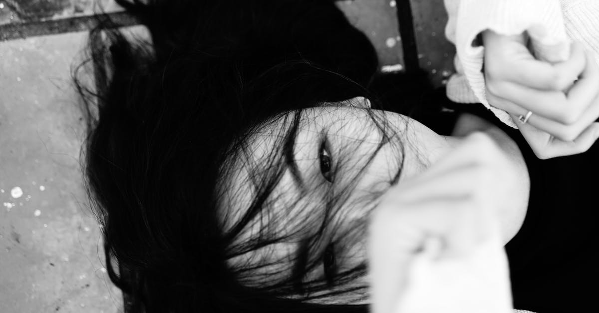 Is Defense cumulative or individual? - Overhead of black and white dark haired female showing fists while lying on tiled pavement and looking at camera