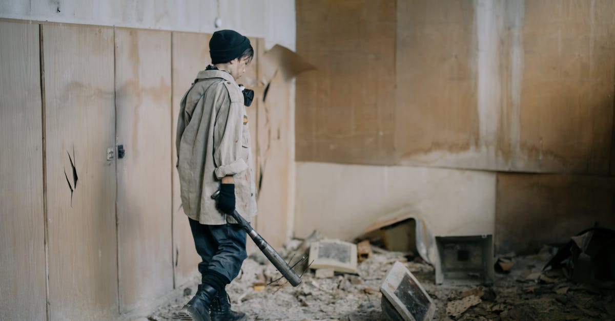 Is Defense Damage Reduction? - Man in White Dress Shirt and Black Pants Holding Black Metal Stick