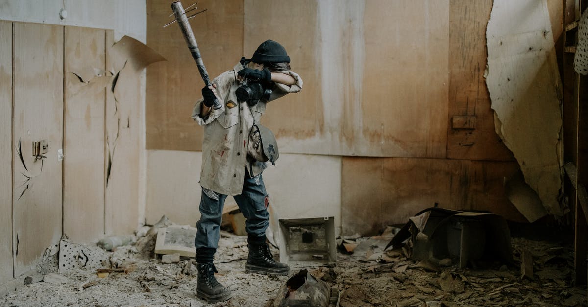 Is Defense Damage Reduction? - Man in Black and White Camouflage Uniform Holding Rifle