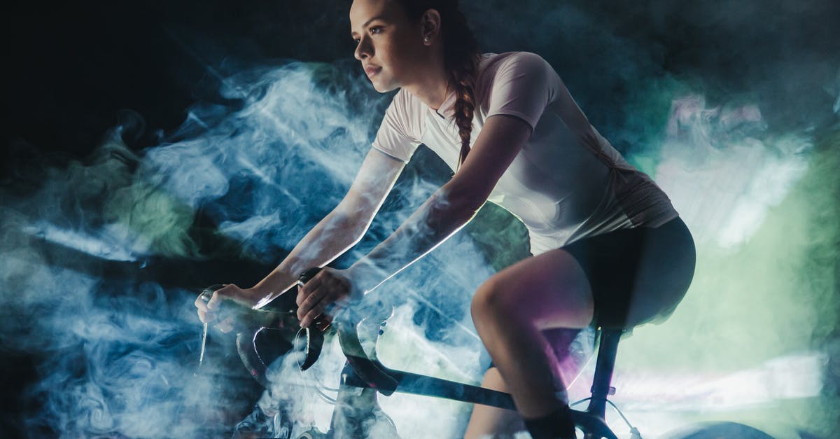 Is fume shroom worth its price? - Young female athlete in active wear with concentrated gaze riding bicycle in shiny cloud while looking forward