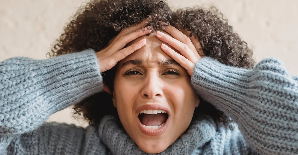 Is Guinsoo's Rage considered a spell? - Expressive African American woman with curly brown hair touching head and yelling against light background