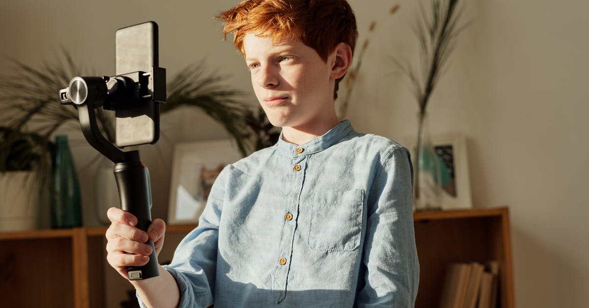 Is it more efficient to hold down R2 or repeatedly click when shooting in Battlefront? - Boy in Blue Dress Shirt Holding Black Selfie Stick Is it more efficient to hold down R2 or repeatedly click when shooting in Battlefront? - Boy in Blue Dress Shirt Holding Black Selfie Stick