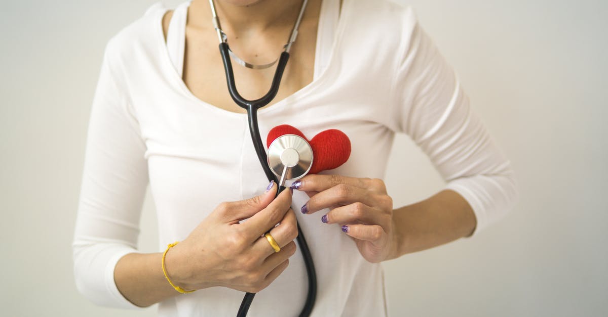 Is it possible to check the health of my Nintendo DS battery? - Unrecognizable female wearing white shirt while standing on white background with diaphragm of stethoscope on red handmade heart in room