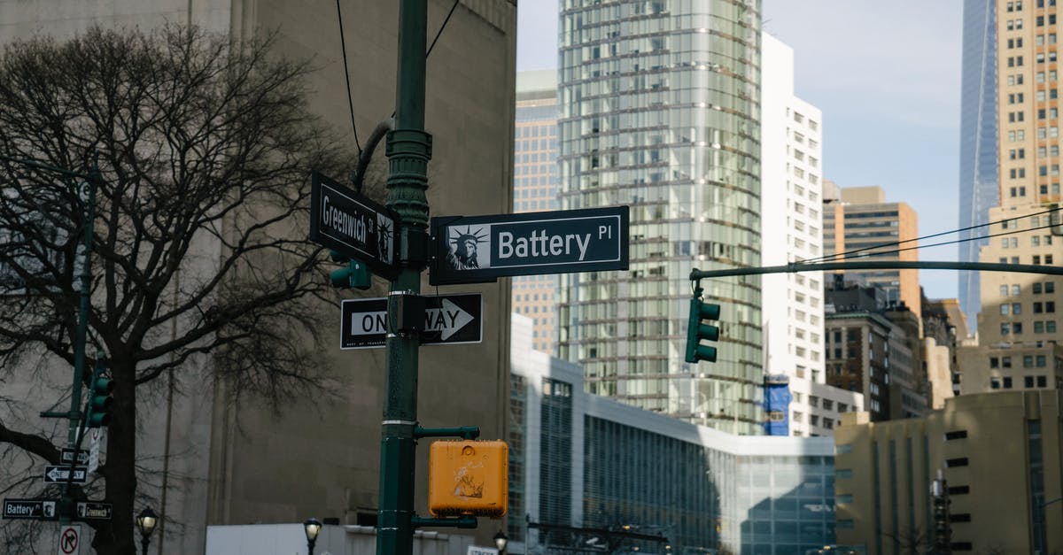 Is it possible to Contain the Traffic Light without stopping? - Traffic lights and street signs near skyscrapers