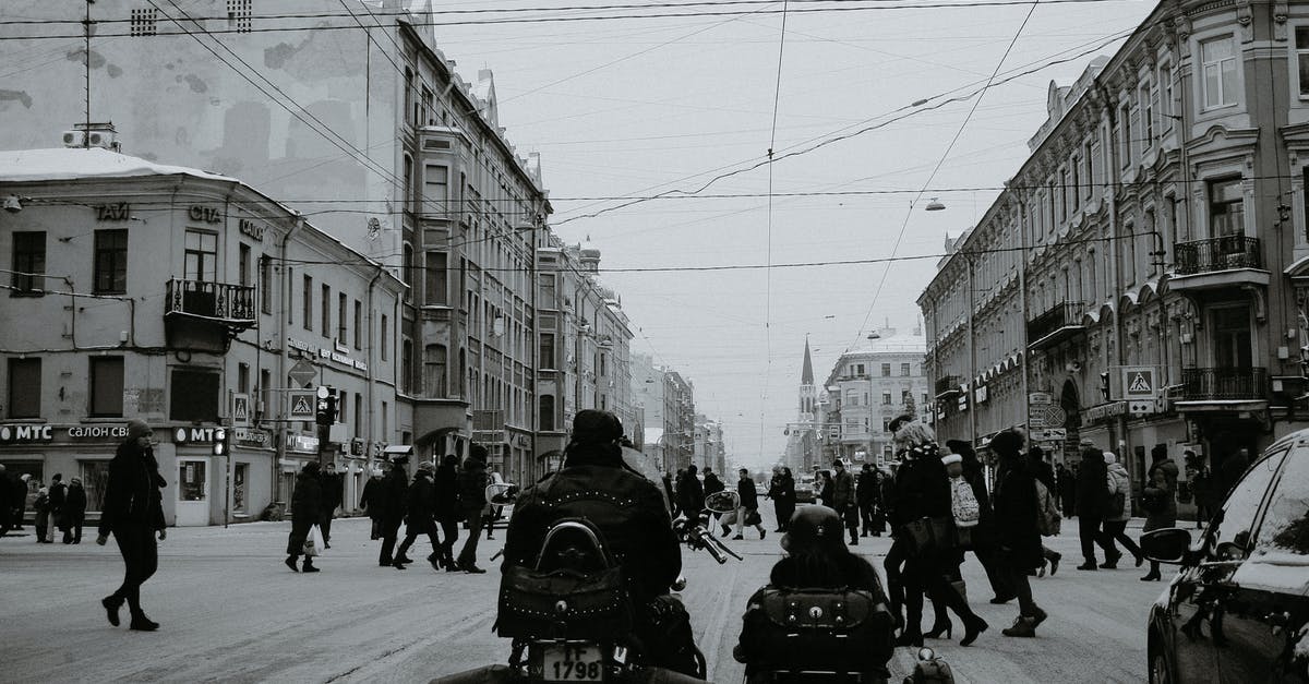 Is it possible to Contain the Traffic Light without stopping? - Black and white of people crossing asphalt road while cars and motorcycle with sidecar waiting for permission signal of traffic light in city in daylight