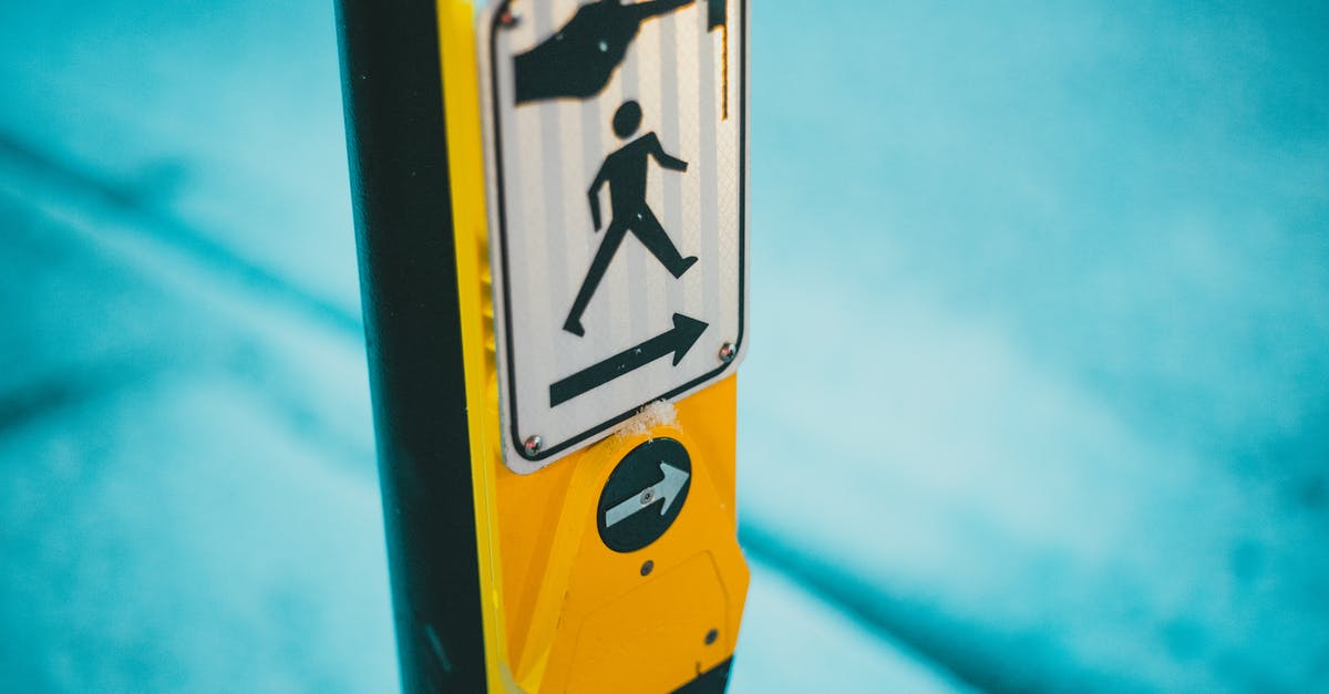 Is it possible to Contain the Traffic Light without stopping? - Selective focus of blind and deaf friendly pedestrian crosswalk control button for changing traffic lights and crossing street on zebra in traffic with sign on street