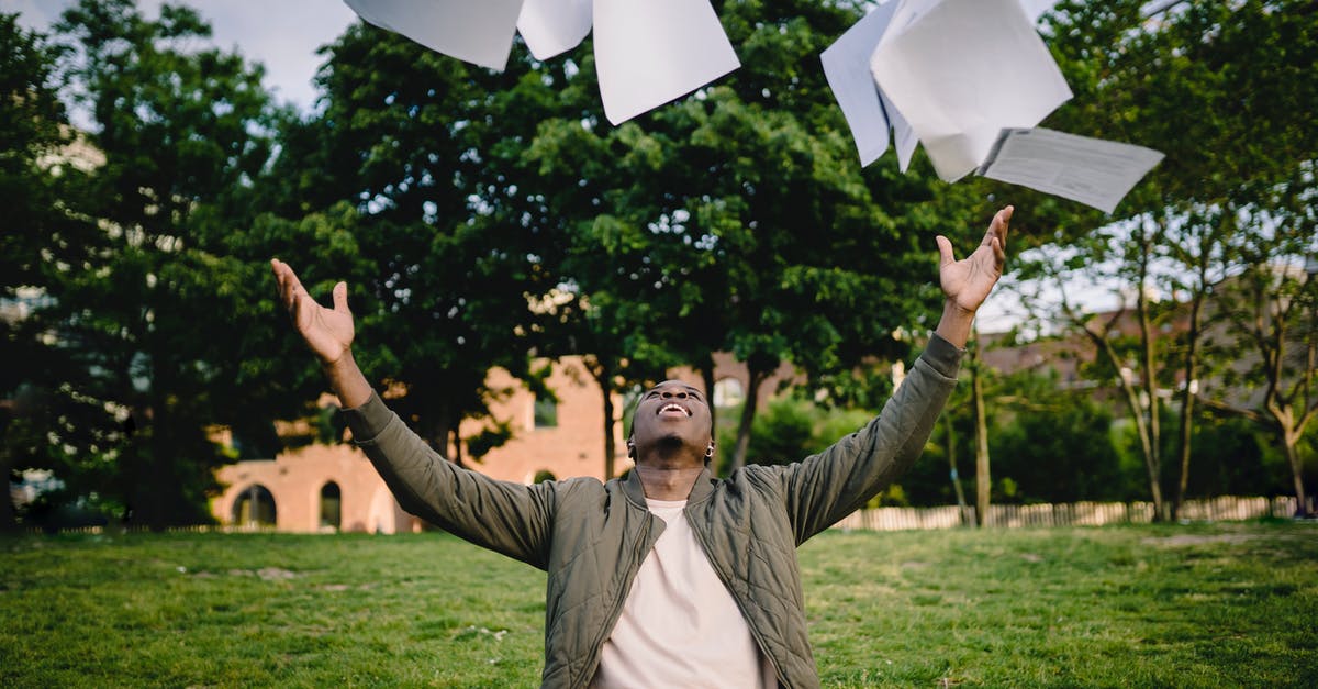 Is it possible to get a Free Magic Shield? - Happy young African American male student in casual outfit tossing university papers in air while having fun in green park after successfully completing academic assignments