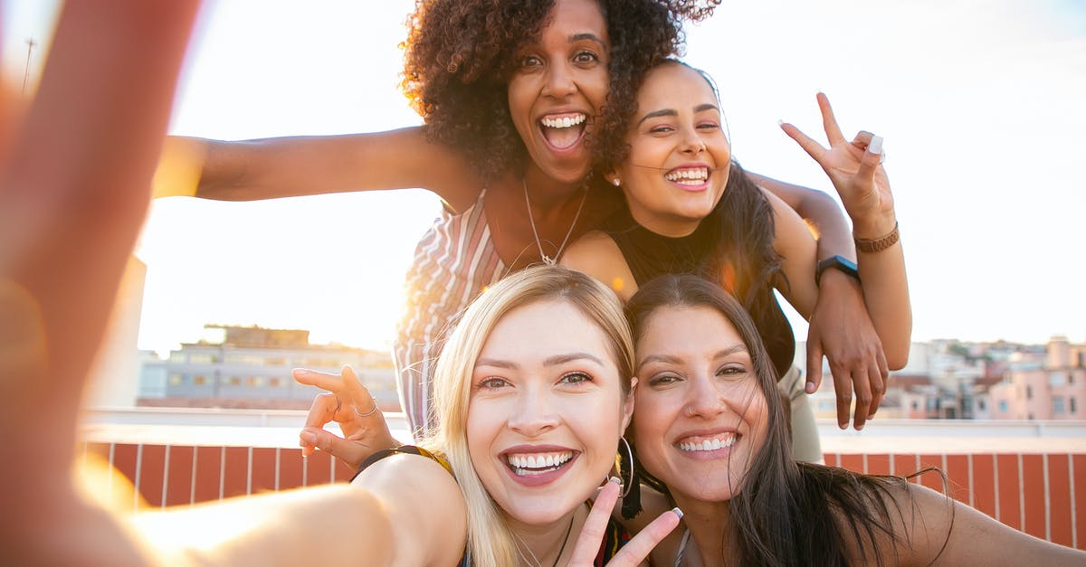 Is it possible to have minimap zoomed out by default? - Cheerful young diverse women showing V sign while taking selfie on rooftop