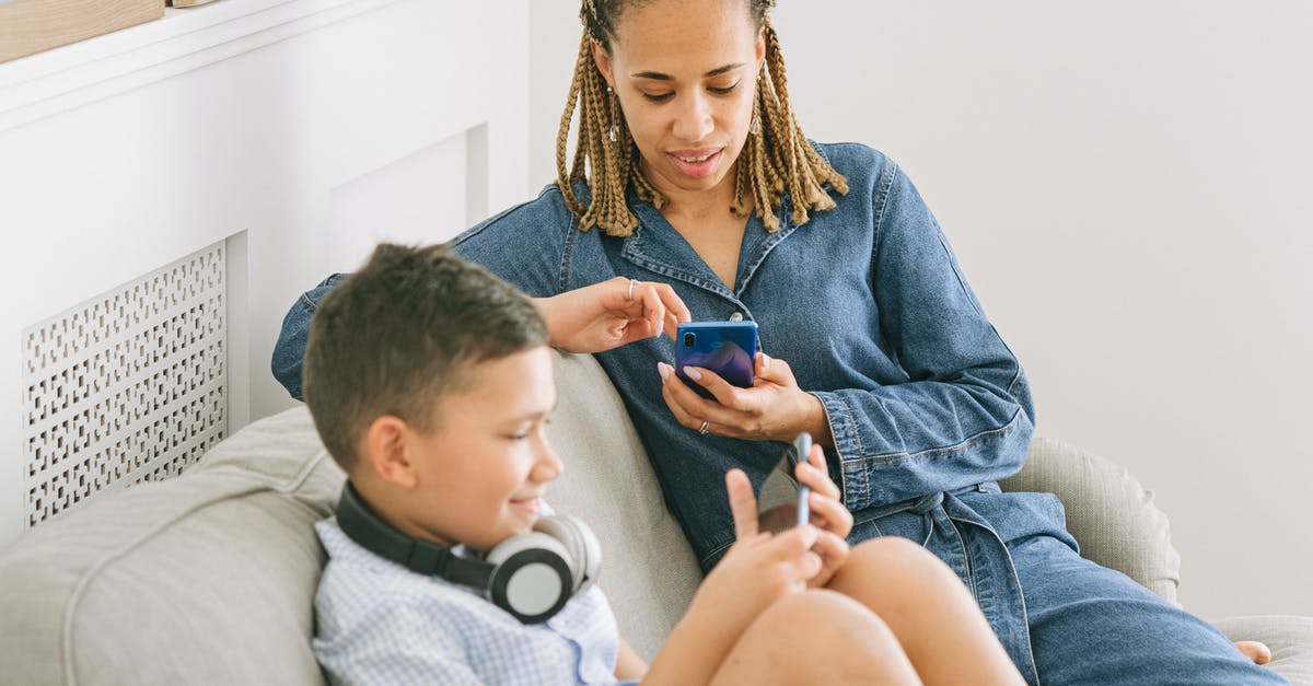 Is it possible to play ARK with two PS4 on LAN? - Woman in Blue Denim Jacket Sitting Beside a Boy 