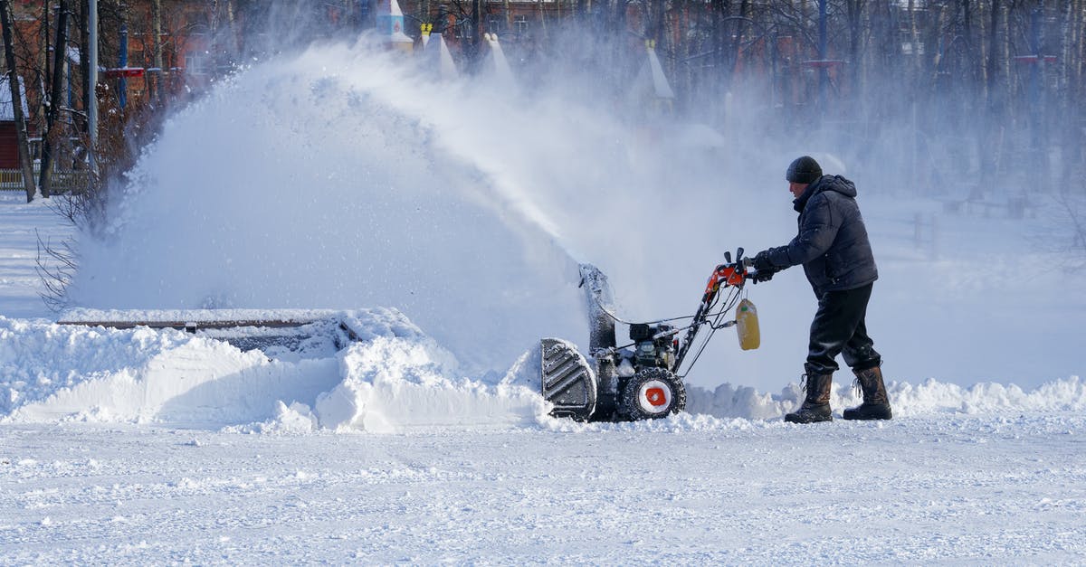 Is it possible to remove viewscreen weather effects? - Full body man in warm clothes walking with snow thrower while cleaning yard in town