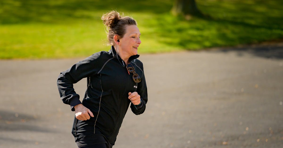 Is it possible to run out of unlock tokens on Zombies? - Woman in Active Wear Jogging on Gray Asphalt Road