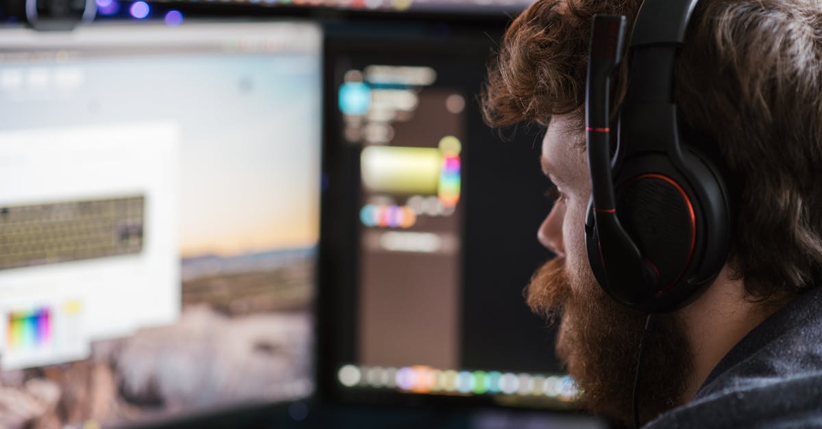 Is it possible to use multiple keyboards? - Crop man in headphones working on computer