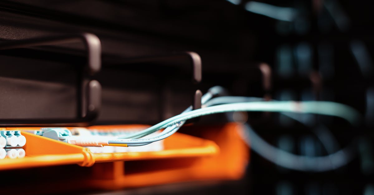 Is it possible to use multiple keyboards? - Blue wires connected to contemporary electronic equipment with multiple inputs on blur background